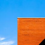 orange brick building with shadow 23 2148252772