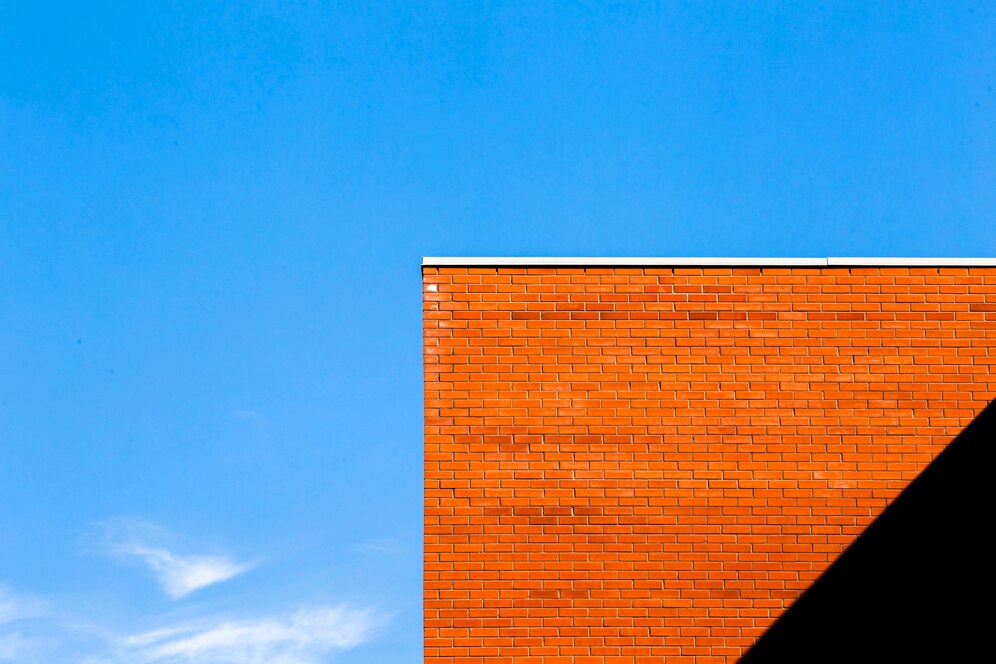 orange brick building with shadow 23 2148252772